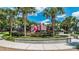 View of a colorful, castle-themed playground in a well-maintained community park with walking paths at 2509 Archfeld Blvd, Kissimmee, FL 34746