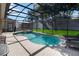 Sparkling screened pool and spa with brick patio in a private backyard at 2509 Archfeld Blvd, Kissimmee, FL 34746