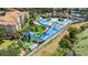 Aerial view of community waterpark with pools, slides, and lush landscaping at 2509 Archfeld Blvd, Kissimmee, FL 34746