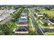 Aerial view of a residential neighborhood featuring homes, palm trees and green lawns at 254 Andalusia Loop, Davenport, FL 33837