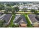 Aerial view of a home featuring solar panels, a brick driveway, and surrounded by well-maintained lawns at 254 Andalusia Loop, Davenport, FL 33837