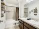 The bathroom features a double sink vanity with granite countertop, shower, and bath at 254 Andalusia Loop, Davenport, FL 33837