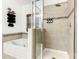 Bright bathroom features a glass-enclosed shower, soaking tub, and decorative mosaic tile accents at 254 Andalusia Loop, Davenport, FL 33837