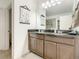 Bright bathroom with double vanity, granite countertops, and a view into the shower for a luxurious feel at 254 Andalusia Loop, Davenport, FL 33837
