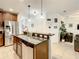 Stylish kitchen with stainless steel appliances, a granite breakfast bar, and open access to the living areas at 254 Andalusia Loop, Davenport, FL 33837