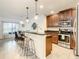 Open kitchen featuring stainless steel appliances, granite countertops, a breakfast bar and barstool seating at 254 Andalusia Loop, Davenport, FL 33837