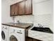 Functional laundry room with washer, dryer, sink, and ample cabinet space at 254 Andalusia Loop, Davenport, FL 33837