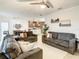 Inviting living room with comfortable sofas, white rug, and open flow to the dining area and kitchen at 254 Andalusia Loop, Davenport, FL 33837