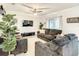Comfortable living room with a TV, ceiling fan, ample seating, and natural light creating a welcoming atmosphere at 254 Andalusia Loop, Davenport, FL 33837