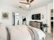 Serene main bedroom featuring neutral tones, modern furniture, and a spacious layout with a view into the bathroom at 254 Andalusia Loop, Davenport, FL 33837