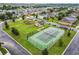 Aerial view of community tennis court and playground, with houses and parking in the background at 254 Andalusia Loop, Davenport, FL 33837