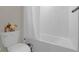 Clean bathroom with a white tile shower, bathtub, and toilet at 2613 Camden Park Loop, Davenport, FL 33837