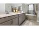 Bright bathroom featuring a double vanity, soaking tub and glass enclosed shower at 2613 Camden Park Loop, Davenport, FL 33837
