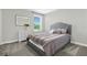 Neutral bedroom with a tufted headboard, plush bedding, and a bright window at 2613 Camden Park Loop, Davenport, FL 33837