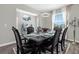 Elegant dining room with decorative chandelier, dark wood table, and decorative display shelves at 2613 Camden Park Loop, Davenport, FL 33837