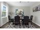 Formal dining room showcasing an elegant chandelier, dark wood table, and decorative area rug at 2613 Camden Park Loop, Davenport, FL 33837