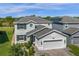 Beautiful two-story home with well-maintained landscaping and a two-car garage on a sunny day at 2613 Camden Park Loop, Davenport, FL 33837