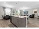 Modern kitchen island with sink, seating, view to dining area and living room, and lots of natural light at 2613 Camden Park Loop, Davenport, FL 33837
