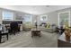 Bright living room with comfortable couches, natural light, and versatile space at 2613 Camden Park Loop, Davenport, FL 33837