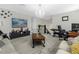 Spacious living room with comfortable seating, decorative chandelier, and staircase views at 2613 Camden Park Loop, Davenport, FL 33837