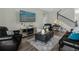 Cozy living room featuring tile flooring, comfortable leather seating, and staircase with modern railings at 2613 Camden Park Loop, Davenport, FL 33837