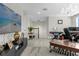 Open living area showcasing a modern chandelier, staircase, and comfortable seating arrangement at 2613 Camden Park Loop, Davenport, FL 33837