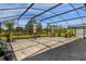 Screened patio offers a covered outdoor living space with brick floors and views of the backyard at 2613 Camden Park Loop, Davenport, FL 33837