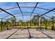 Outdoor patio with a screen enclosure featuring brick pavers and tables at 2613 Camden Park Loop, Davenport, FL 33837