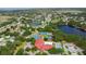 Beautiful aerial view of the community featuring a pool, tennis courts, lake and clubhouse at 26901 Racquet Cir, Leesburg, FL 34748