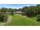 Spacious backyard with lush green grass and mature trees at 26901 Racquet Cir, Leesburg, FL 34748
