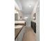 Well-lit bathroom featuring a single sink vanity and tiled walk-in shower at 26901 Racquet Cir, Leesburg, FL 34748