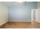 Empty bedroom with tile floors, light blue painted walls and a ceiling fan at 26901 Racquet Cir, Leesburg, FL 34748