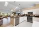 Spacious kitchen with granite countertops open to living area at 26901 Racquet Cir, Leesburg, FL 34748