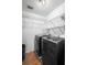 Convenient laundry room with modern washer and dryer and wire shelving at 26901 Racquet Cir, Leesburg, FL 34748