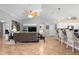 Spacious living area with bar seating, open floor plan, and seamless transition to the kitchen at 26901 Racquet Cir, Leesburg, FL 34748