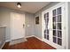 Inviting entryway boasts hardwood floors, white trim, and charming French doors at 297 Sky Valley St, Clermont, FL 34711