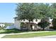 Traditional two-story home featuring mature trees, a well-maintained lawn and neutral exterior paint at 297 Sky Valley St, Clermont, FL 34711