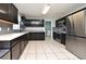 Spacious kitchen with stainless steel appliances, ample counter space, and dark wood cabinets at 297 Sky Valley St, Clermont, FL 34711