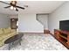Comfortable living room with cozy carpet, ceiling fan, and easy access to the staircase at 297 Sky Valley St, Clermont, FL 34711