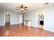 Spacious main bedroom featuring hardwood floors, a ceiling fan, and dual access to closet and bathroom at 297 Sky Valley St, Clermont, FL 34711