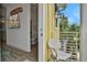 Inviting balcony view with a white chair, complemented by a glimpse of the bathroom and entertainment setup inside at 3083 Key Lime Loop, Kissimmee, FL 34747