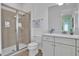 Bright bathroom with tiled shower, modern fixtures, and a sleek vanity at 3083 Key Lime Loop, Kissimmee, FL 34747