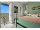 Charming bedroom with a decorative bed, a cozy balcony, and natural light from the windows at 3083 Key Lime Loop, Kissimmee, FL 34747
