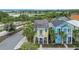 Charming home with a front porch, colorful exterior, and palm trees at 3083 Key Lime Loop, Kissimmee, FL 34747