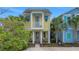 Charming two-story home with a yellow exterior, blue trim, and a small front porch at 3083 Key Lime Loop, Kissimmee, FL 34747