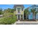 Charming home exterior with colorful accents, a small balcony, and lush landscaping at 3083 Key Lime Loop, Kissimmee, FL 34747
