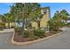 Charming home exterior featuring colorful paint, lush landscaping, and a welcoming outdoor seating area at 3083 Key Lime Loop, Kissimmee, FL 34747