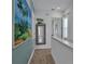 Upstairs hallway features beach artwork, decorative mirror, and views of the home's interior at 3083 Key Lime Loop, Kissimmee, FL 34747