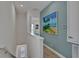 Upstairs landing features beach-themed decor and artwork, creating a coastal ambiance at 3083 Key Lime Loop, Kissimmee, FL 34747