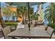 Inviting outdoor seating area with umbrella and lush landscaping for enjoying the outdoors at 3083 Key Lime Loop, Kissimmee, FL 34747
